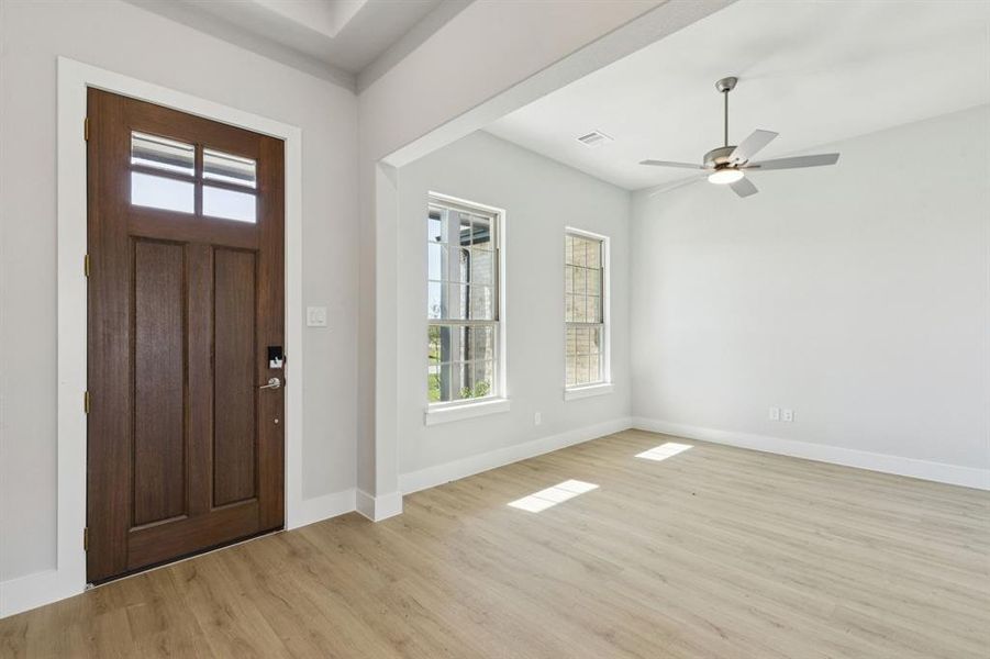 Foyer entrance featuring light wood-type flooring and ceiling fan