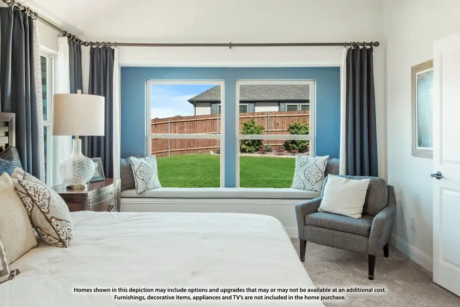 Bedroom with built-in window seat, large windows overlooking backyard, blue accent wall, and gray curtains Bedroom with built-in window seat, large windows overlooking backyard, blue accent wall, and gray curtains