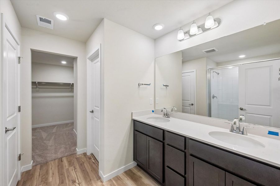 A bathroom with a large mirror.