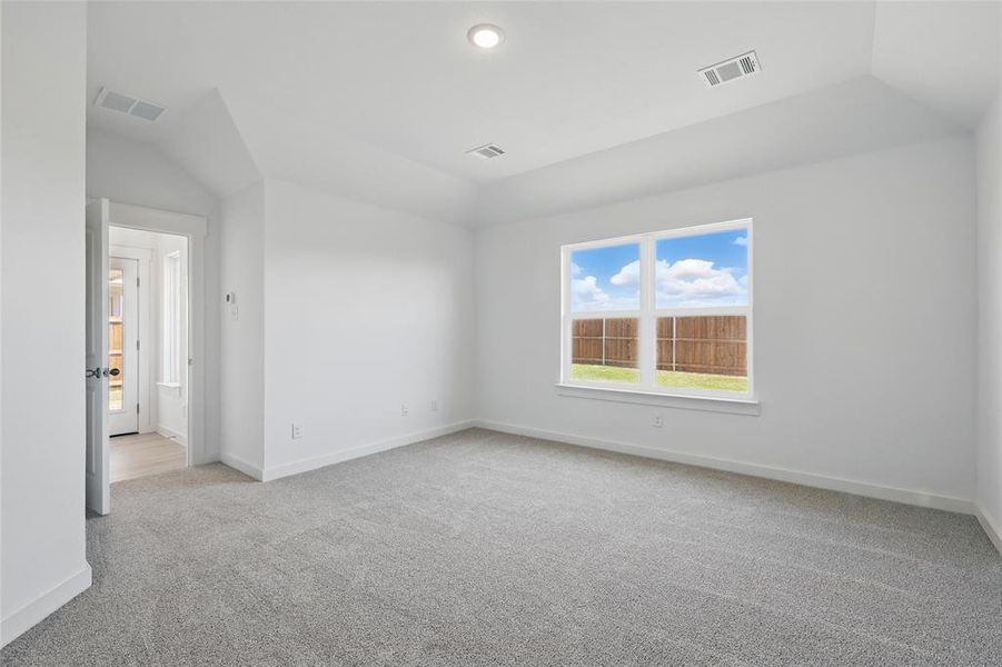 Empty room featuring light carpet, visible vents, and baseboards Empty room featuring light carpet, visible vents, and baseboards