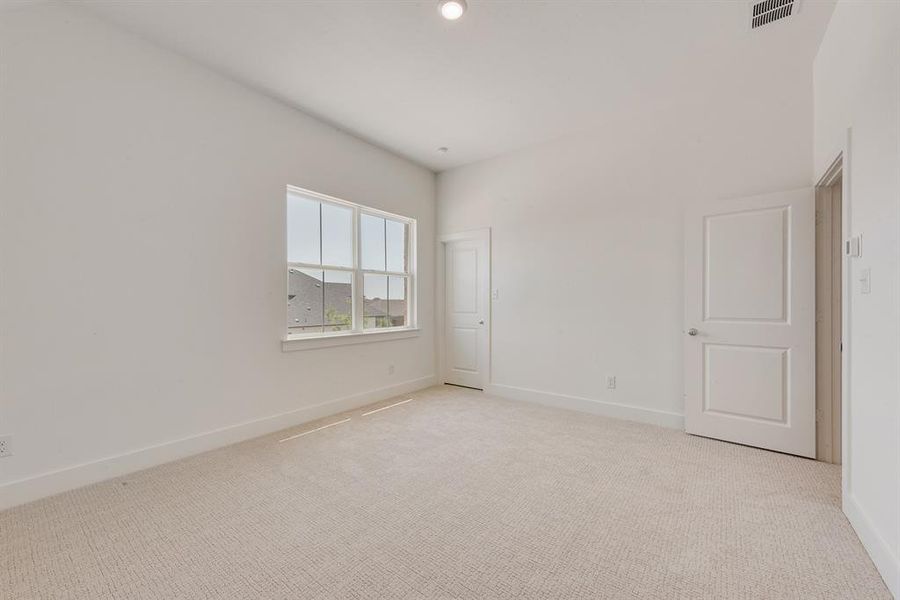 Unfurnished bedroom featuring light carpet and recessed lighting Unfurnished bedroom featuring light carpet and recessed lighting