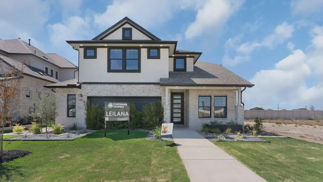 Representative exterior photo of a completed home built from the Leilana by Chesmar Homes in The Grove at Blackhawk, Pflugerville, TX (Image 1). Representative exterior photo of a completed home built from the Leilana by Chesmar Homes in The Grove at Blackhawk, Pflugerville, TX (Image 1).