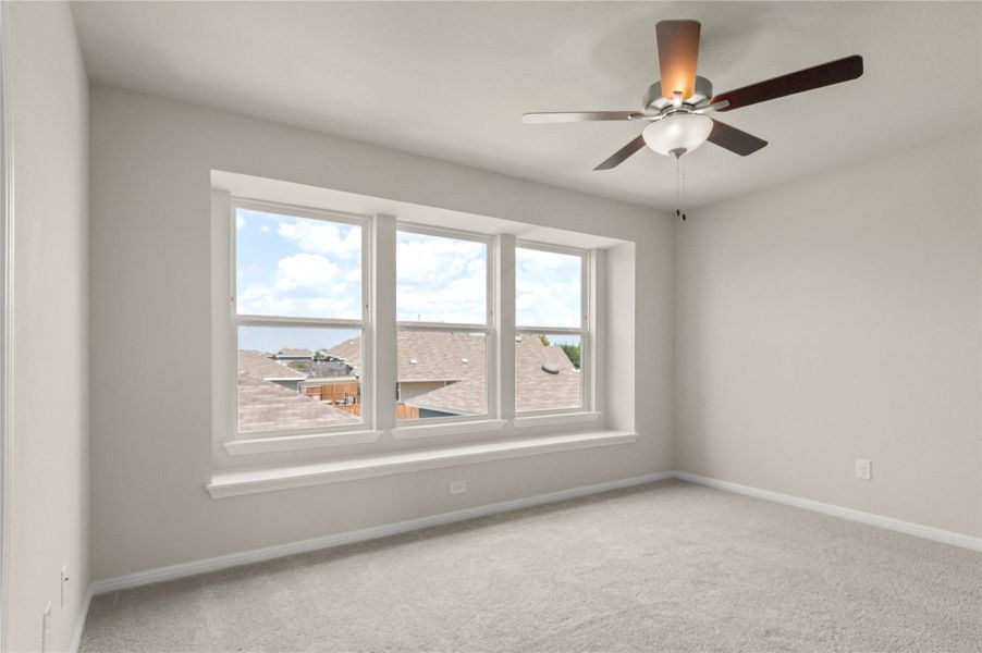 Spare room with carpet and a ceiling fan Spare room with carpet and a ceiling fan