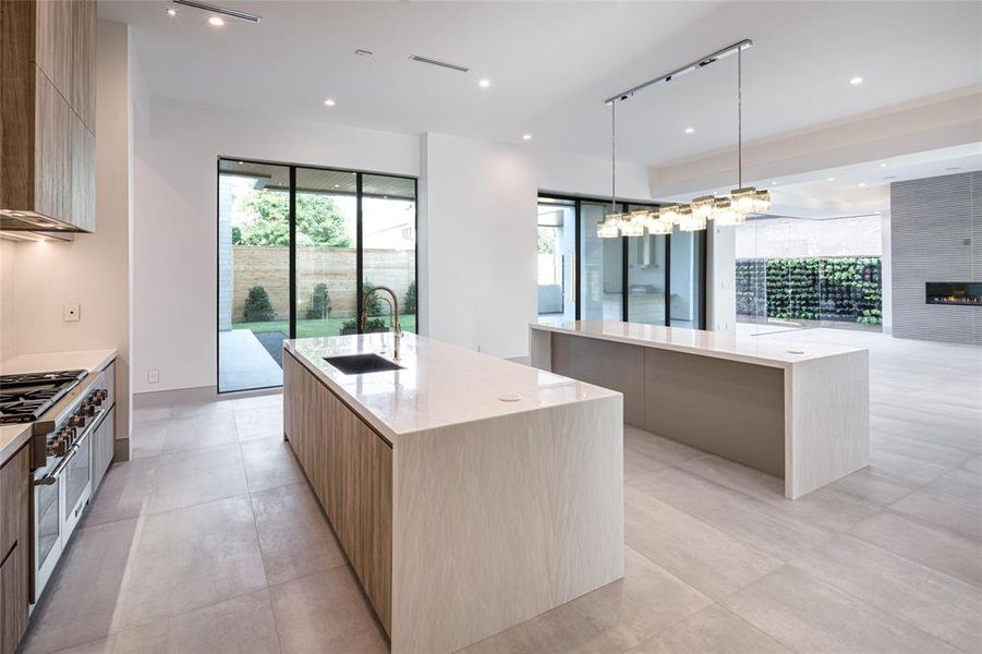 State-of-the-art kitchen with a tone of Chic sophistication, functional and timeless elegance. Double islands and designer's crystal hanging pendant.