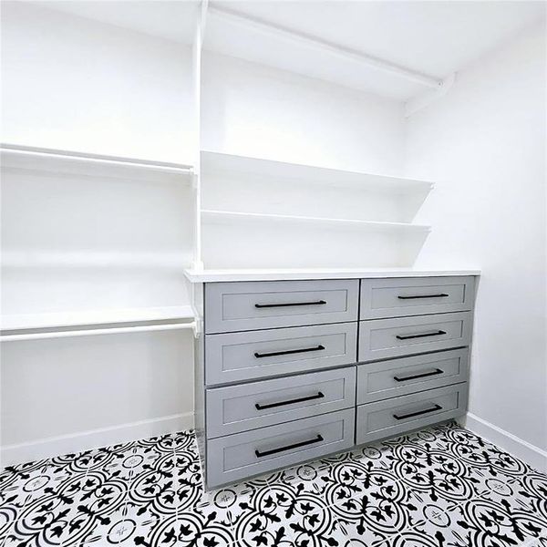 Primary closet with built-in soft close drawers.