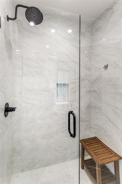 Bathroom featuring a marble finish shower Bathroom featuring a marble finish shower