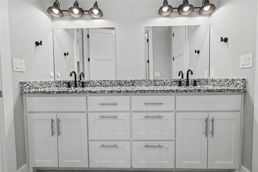 Double vanity with white cabinetry and brushed nickel hardware