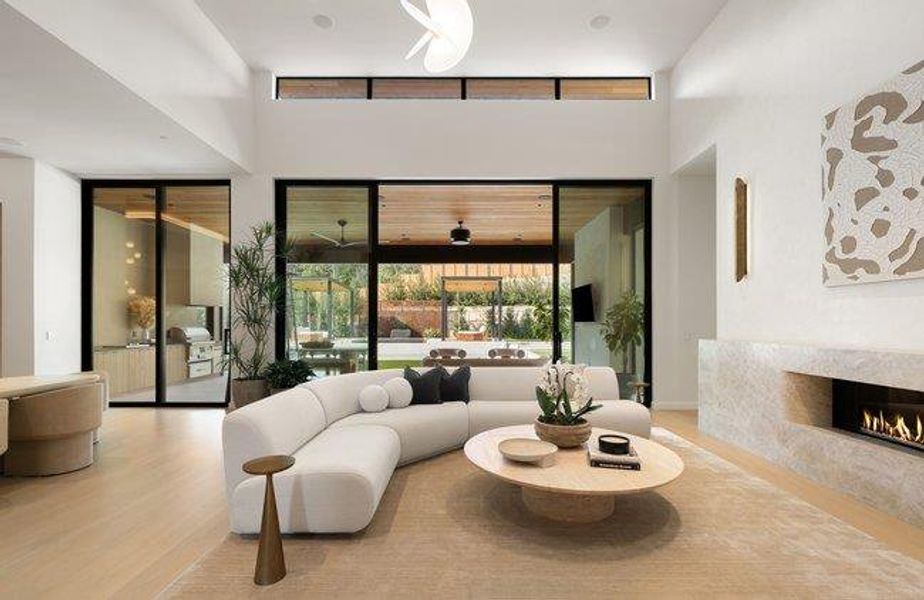 Spacious living area featuring high ceilings, clerestory windows, and light wood-finish flooring