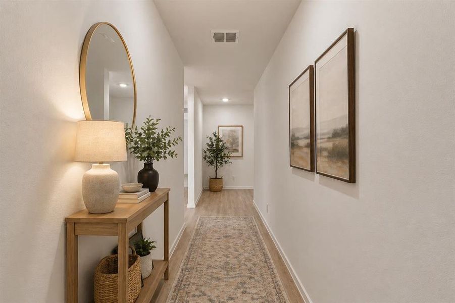 Hallway with wood-finish flooring and light neutral walls Hallway with wood-finish flooring and light neutral walls