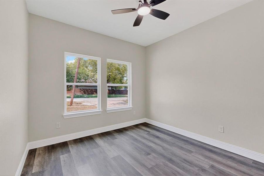 Spare room with wood finished floors and a ceiling fan Spare room with wood finished floors and a ceiling fan