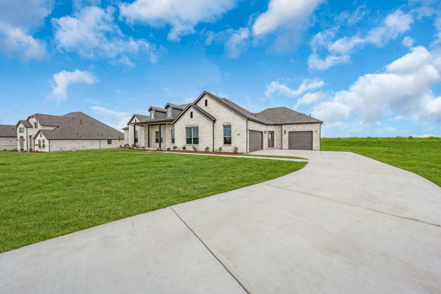 Front exterior of a new home in Berkshire Estates, Mesquite, TX, highlighting curb appeal (Image 27). Front exterior of a new home in Berkshire Estates, Mesquite, TX, highlighting curb appeal (Image 27).