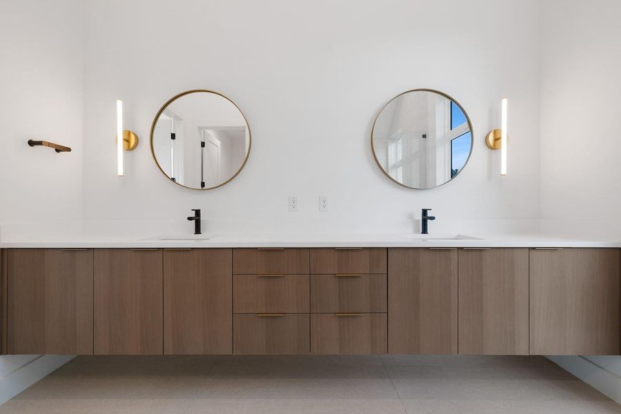 Bathroom featuring double vanity and light tile patterned floors
