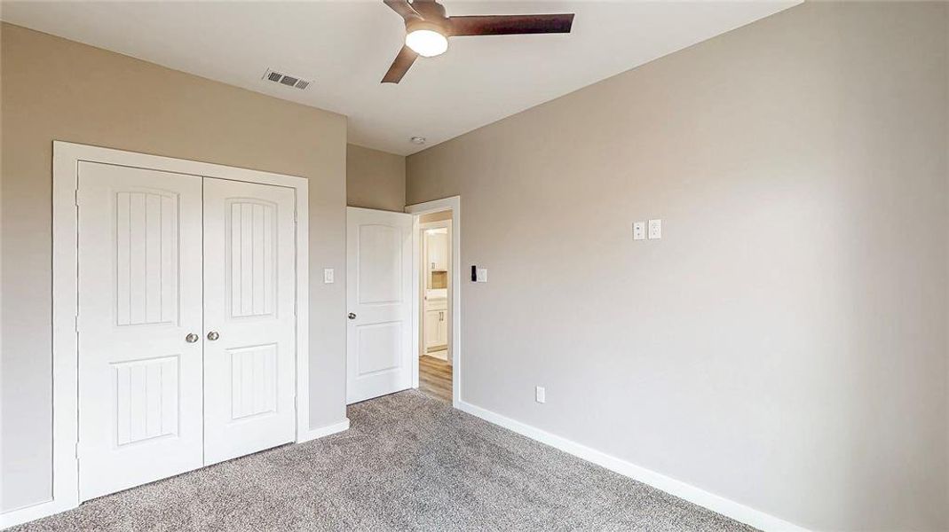 Front right bedroom with ample closet space & tall ceilings