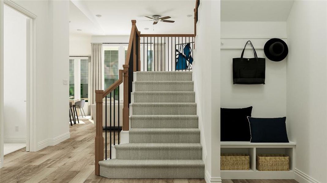 Stairway featuring ceiling fan and wood-type flooring