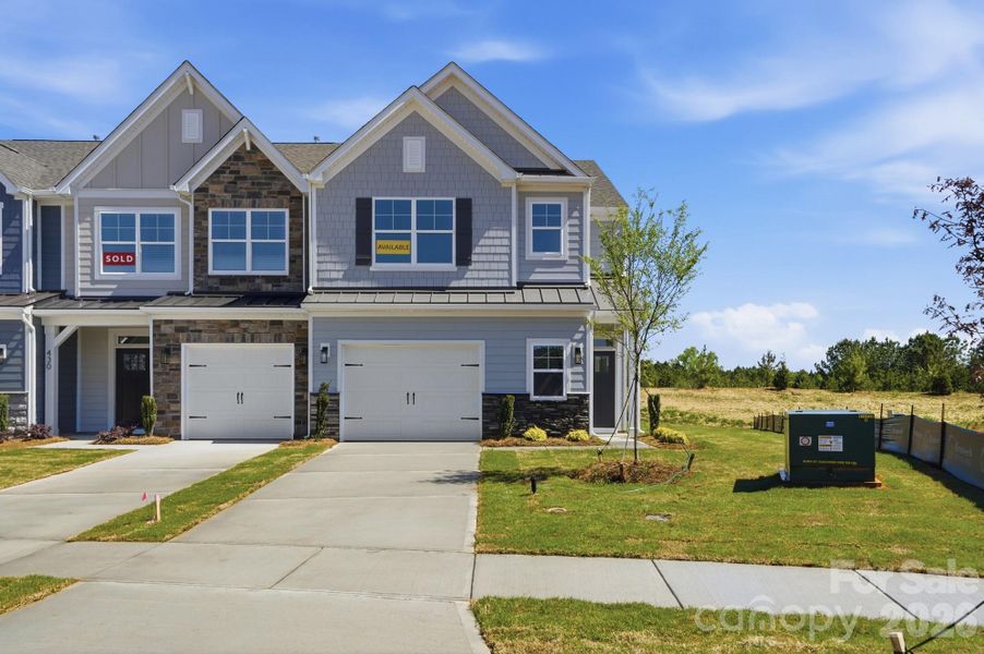 Homesite 110 features an end-unit townhome with an oversized garage