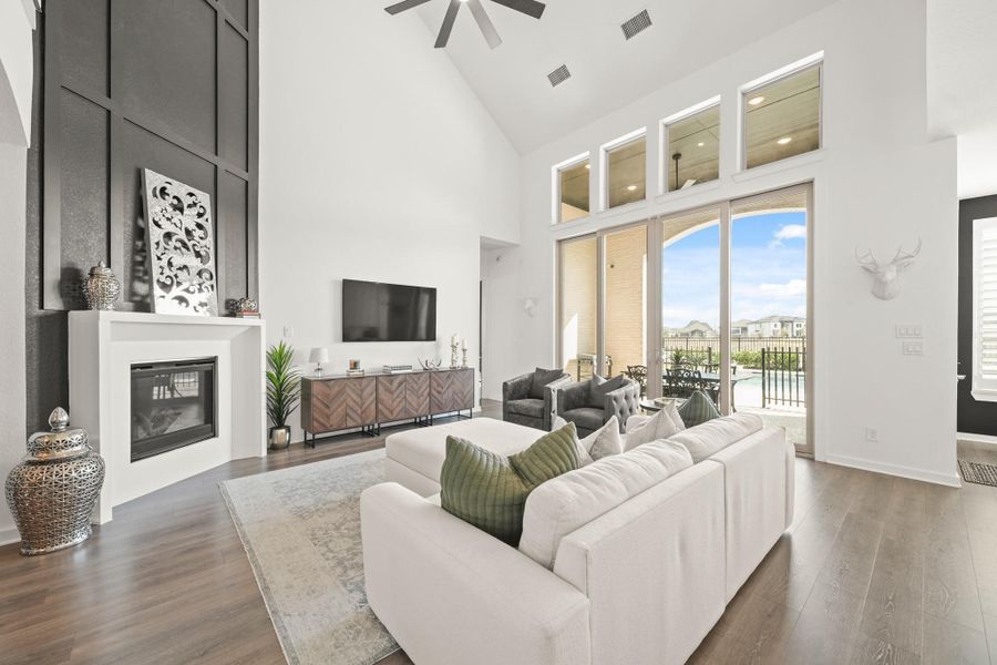 A 12-foot wide by 10-foot tall center sliding patio door with fixed windows above, opens to the covered patio and pool area, creating a seamless indoor/outdoor connection.