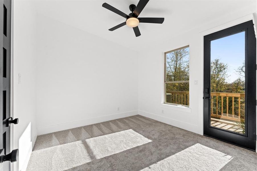 Secondary bedroom with direct access to the rear balcony, where you can enjoy breathtaking sunsets. Both the front and rear balconies provide tranquil outdoor spaces with serene views.