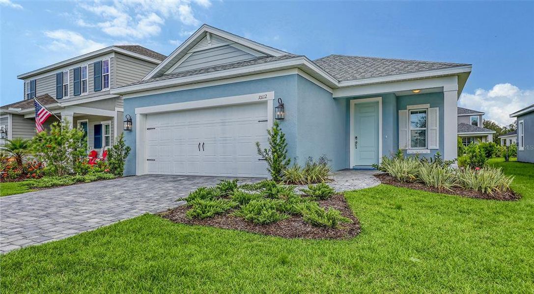Front exterior of a new home in Wildleaf, Parrish, FL, highlighting curb appeal (Image 1).