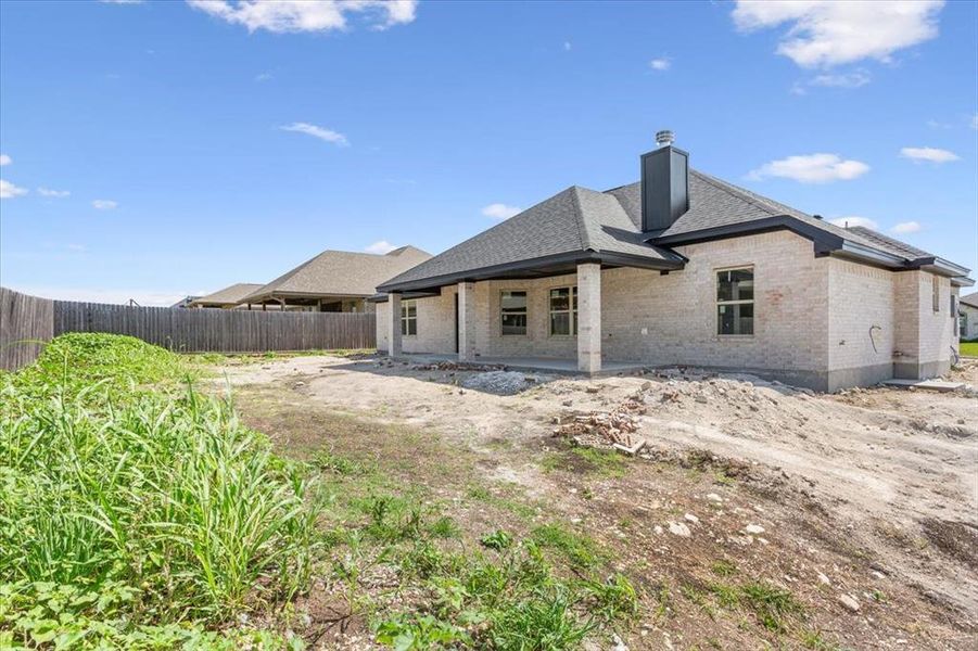 Back of house featuring brick siding, a chimney, and a shingled roof Back of house featuring brick siding, a chimney, and a shingled roof