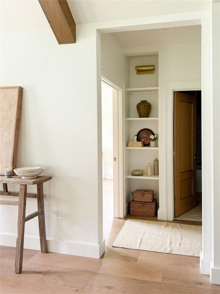 Hallway off the living room has custom featured book shelf beside the hall bath between the 2nd & 3rd bathrooms Hallway off the living room has custom featured book shelf beside the hall bath between the 2nd & 3rd bathrooms
