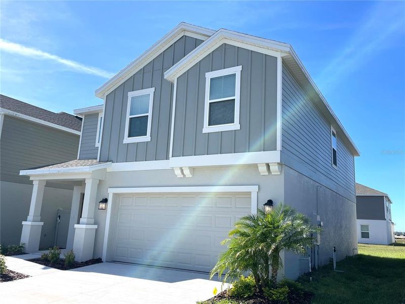 Front exterior of a new home in Ranches at Lake Mcleod, Eagle Lake, FL, highlighting curb appeal (Image 19).