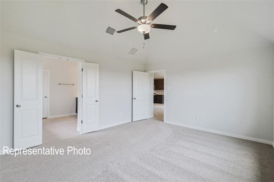 Unfurnished bedroom featuring high vaulted ceiling, ceiling fan, and light carpet