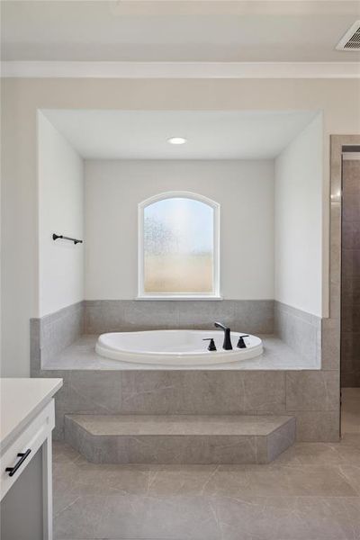 Bathroom with vanity and a relaxing tiled tub