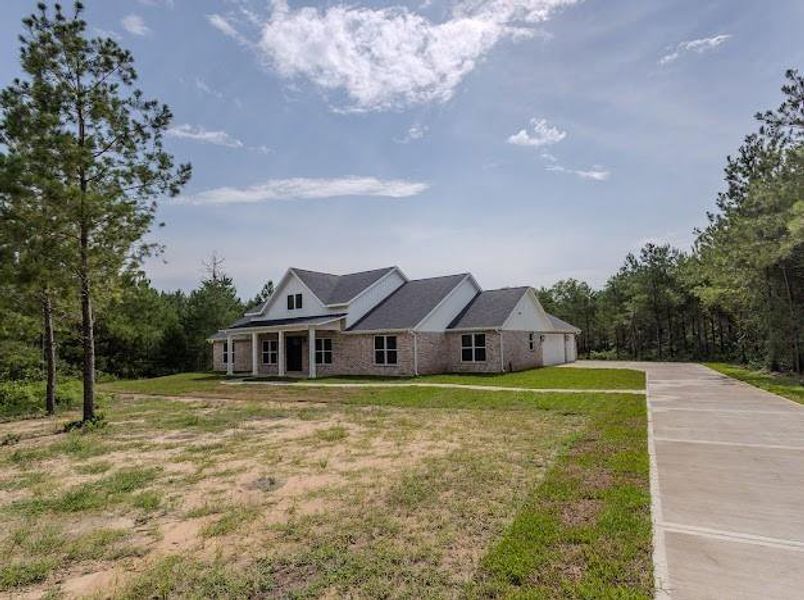 Front exterior of a new home in , Willis, TX, highlighting curb appeal (Image 27). Front exterior of a new home in , Willis, TX, highlighting curb appeal (Image 27).