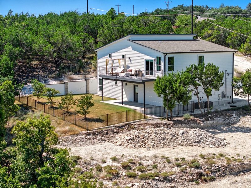 Back of house with a fenced backyard, a patio, and a shingled roof