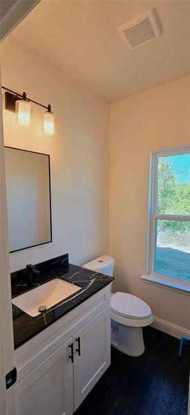 Bathroom featuring vanity and dark wood-type flooring Bathroom featuring vanity and dark wood-type flooring