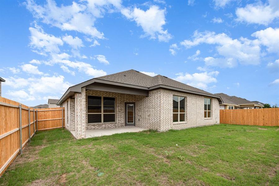 Rear view of property featuring a patio and a yard