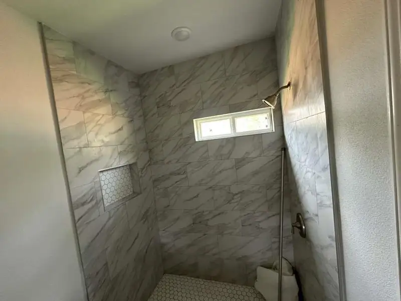 Full bathroom with a shower stall
