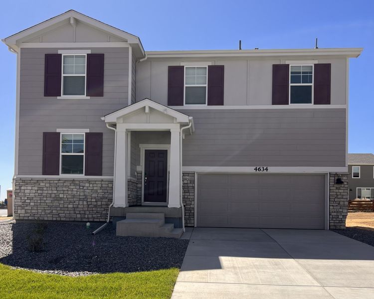 Front exterior of a new home in Revere at Johnstown, Johnstown, CO, highlighting curb appeal (Image 1). Front exterior of a new home in Revere at Johnstown, Johnstown, CO, highlighting curb appeal (Image 1).