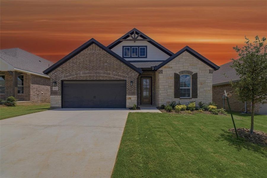 Contemporary home showcasing a brick and stone facade, an attached garage, a gabled roofline, and a manicured lawn Contemporary home showcasing a brick and stone facade, an attached garage, a gabled roofline, and a manicured lawn