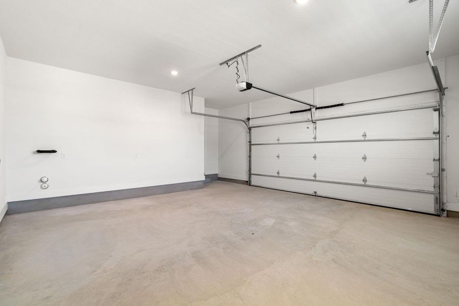 A garage offers abundant space and convenience for vehicles and storage.