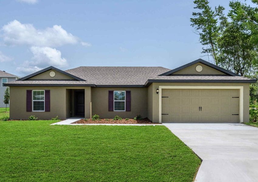 Exterior view of the Caladesi floor plan with a decorative two-car garage and a lush green grass front yard.