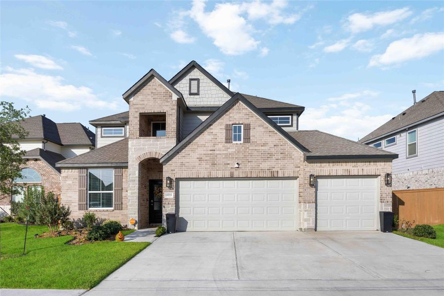 Front exterior with brick/stone elevation and 3-car garage. Front exterior with brick/stone elevation and 3-car garage.
