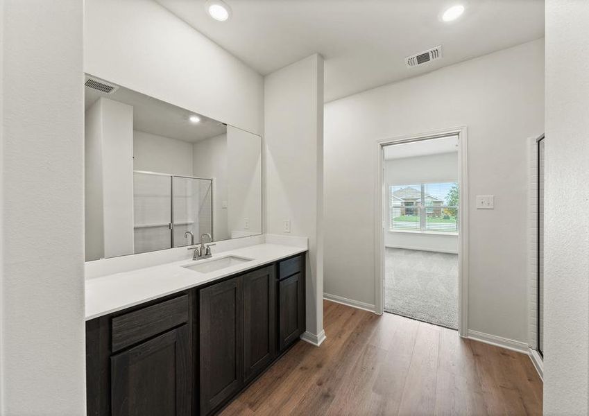 The master bathroom has a large vanity space.