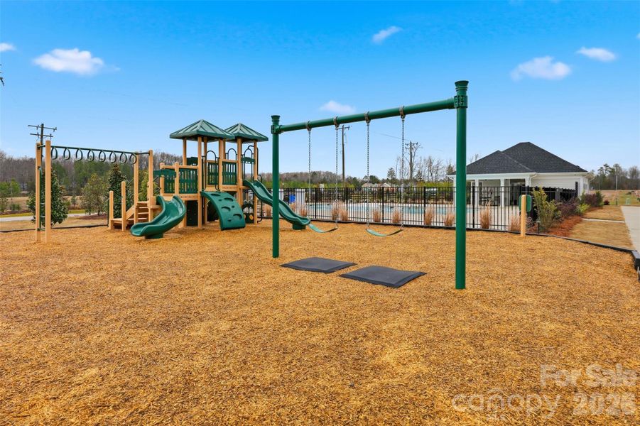 community playground next to pool and cabana- in section of neighborhood across the street
