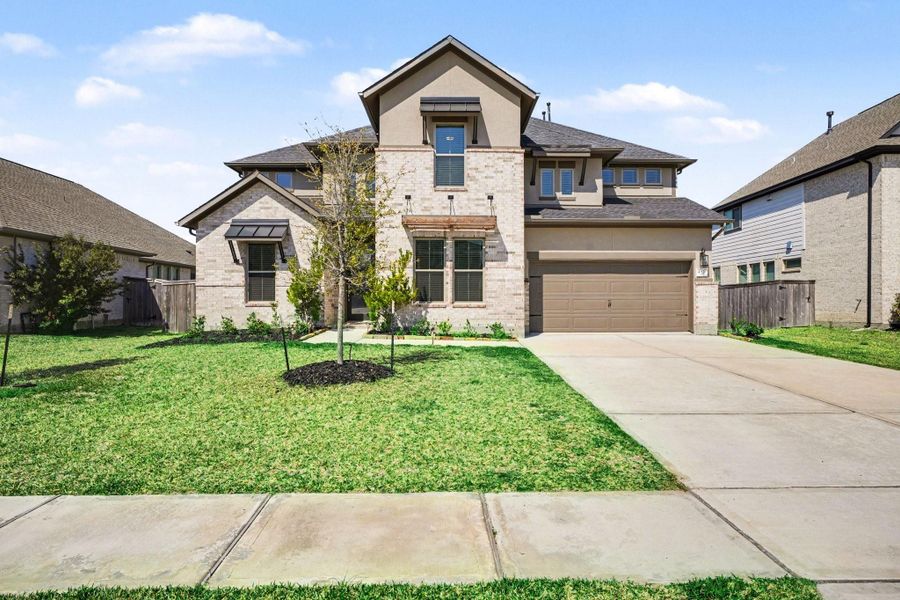 Front exterior of a new home in Coastal Point, League City, TX, highlighting curb appeal (Image 2). Front exterior of a new home in Coastal Point, League City, TX, highlighting curb appeal (Image 2).