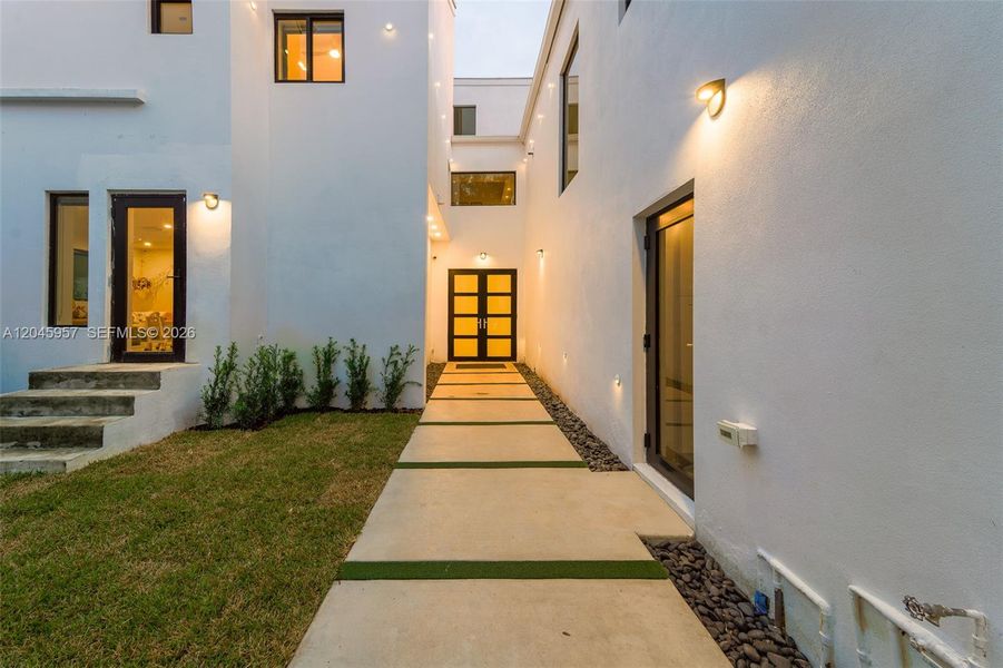 A dramatic architectural entry welcomes you home, setting the tone for the sophisticated design and craftsmanship found throughout the residence.