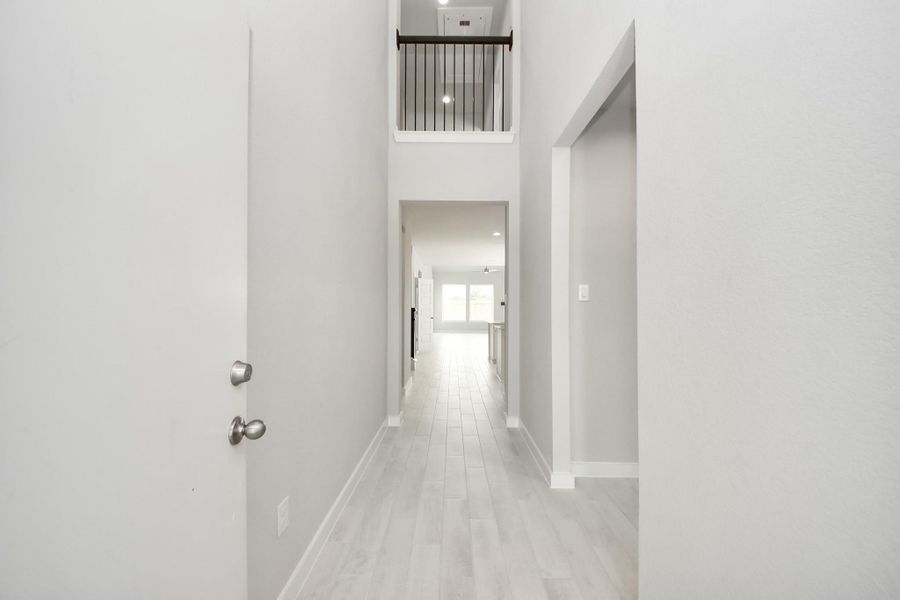 As you step into the threshold of this luxurious home, you'll soon be welcomed by an elegant glass door (to be installed). Inside, soaring ceilings amplify the spaciousness, while the refined wood-look tile flooring and oversized baseboards exude sophistication and charm. As you step into the threshold of this luxurious home, you'll soon be welcomed by an elegant glass door (to be installed). Inside, soaring ceilings amplify the spaciousness, while the refined wood-look tile flooring and oversized baseboards exude sophistication and charm.