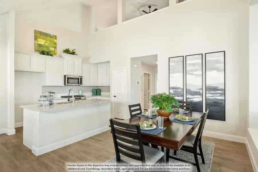 Open-concept kitchen and dining area with white cabinets, granite island, and high ceilings over wood-look floors