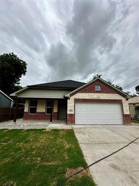 View of front facade with a garage and a front lawn