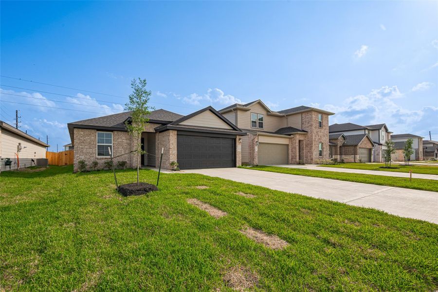 Front exterior of a new home in Tamarron, Fulshear, TX, highlighting curb appeal (Image 31). Front exterior of a new home in Tamarron, Fulshear, TX, highlighting curb appeal (Image 31).
