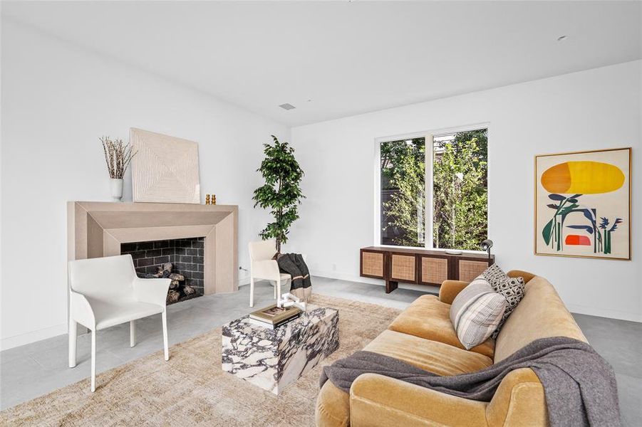 This stylish living room features an Isokern gas fireplace with a wood-burning option, surrounded by a custom limestone mantel that adds a touch of timeless elegance. The room's clean lines, natural light, and modern design elements make it both warm and inviting.