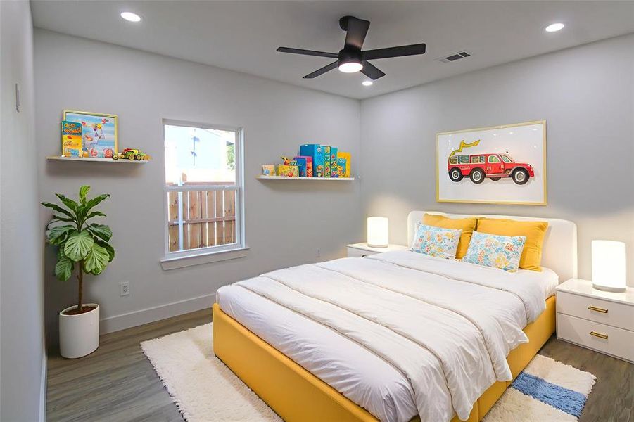 Bedroom featuring wood finished floors, recessed lighting, and a ceiling fan Bedroom featuring wood finished floors, recessed lighting, and a ceiling fan