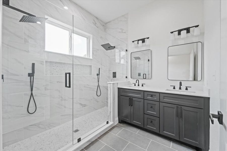 Primary Bathroom featuring a dual vanity with dark wood-finish cabinetry and white countertops