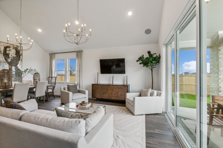 Great room with vaulted ceiling and dual chandeliers