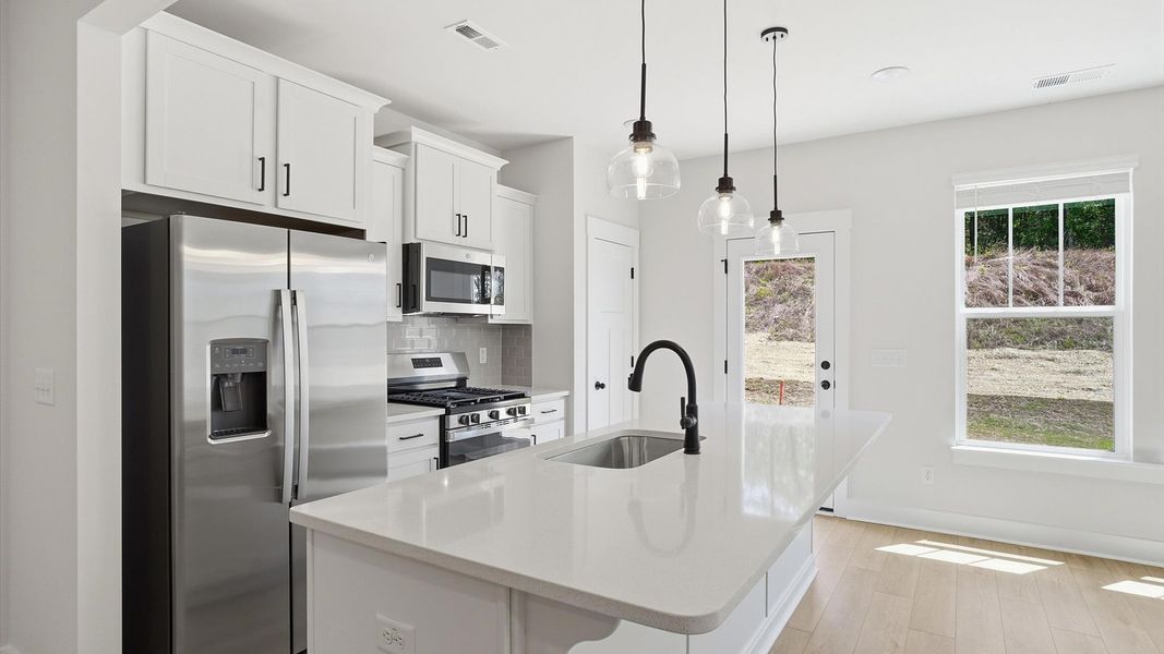 Notable kitchen space with elegant pendant lighting and a large island perfect for entertaining located at Marion Square